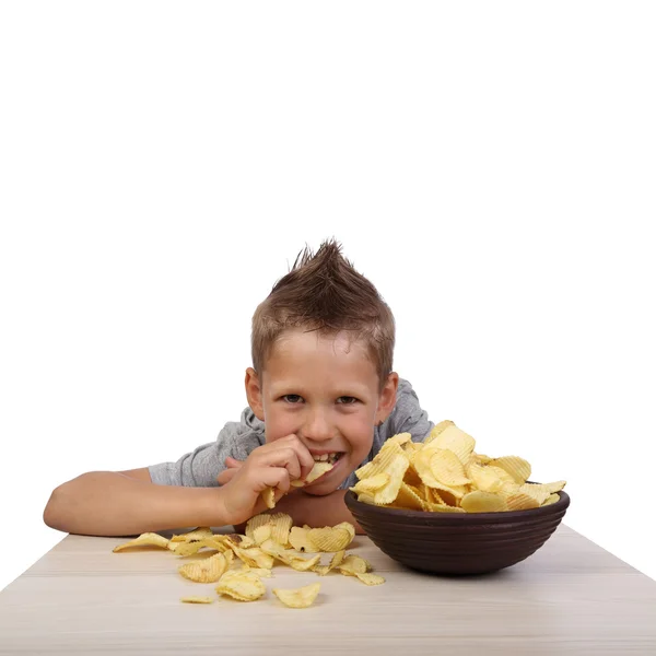 Boy eats chips Royaltyfria Stockbilder