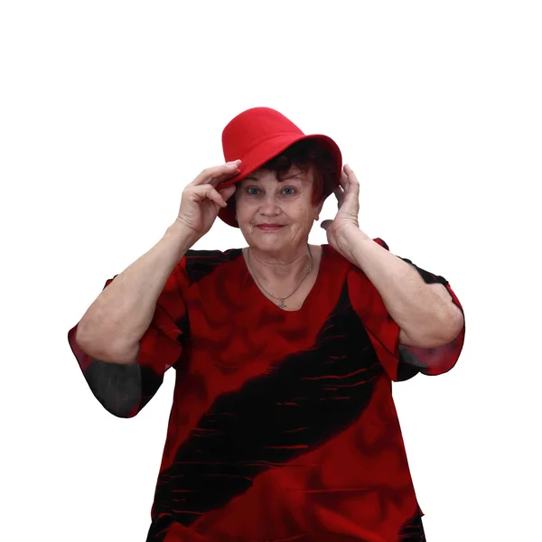 Senior woman in red hat — Stockfoto