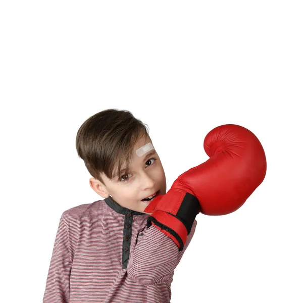 Boy with patch on his forehead unzips boxing glove — Stockfoto