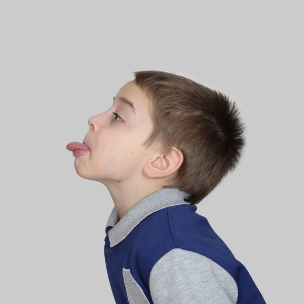 Boy shows his tongue — Stock Photo, Image