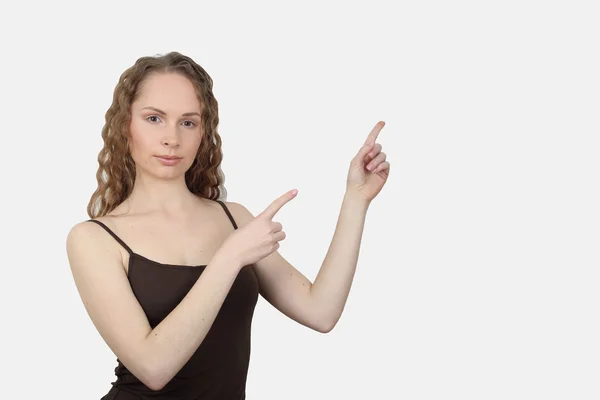 Young woman shows direction of hands — Stock Photo, Image