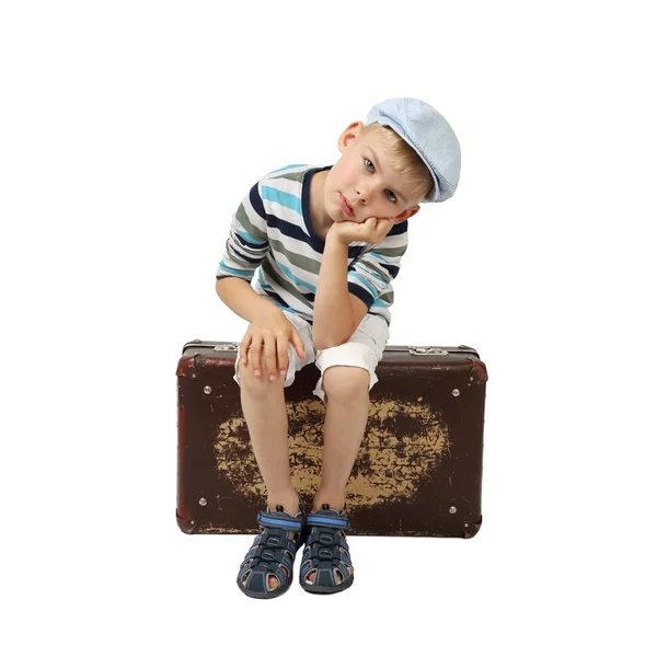 Sad boy sits on vintage suitcase — Φωτογραφία Αρχείου