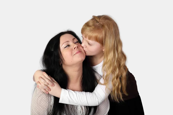 Teenage girl kiss smiling woman — Stock Photo, Image
