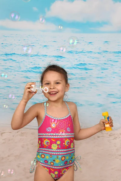 Cute little girl on beach blows bubbles — Φωτογραφία Αρχείου