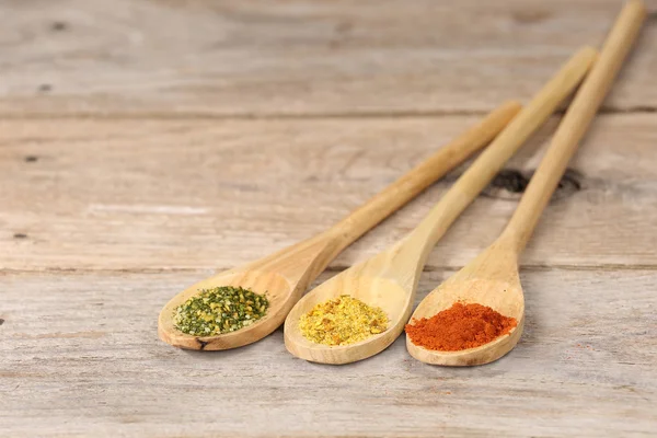 Spices in wooden spoons — Stock Photo, Image