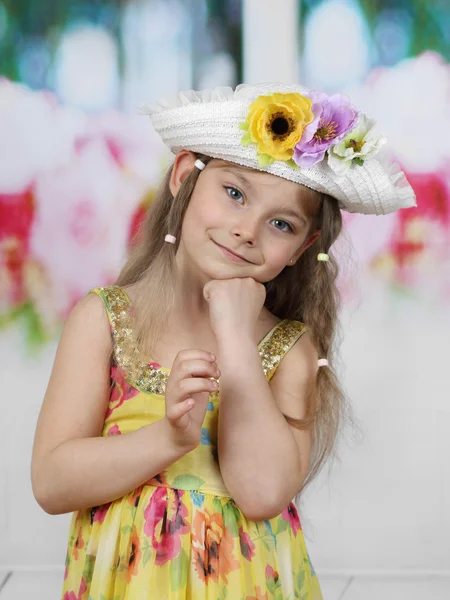 Cute long haired girl in flowers decorated hat portrait — Stockfoto