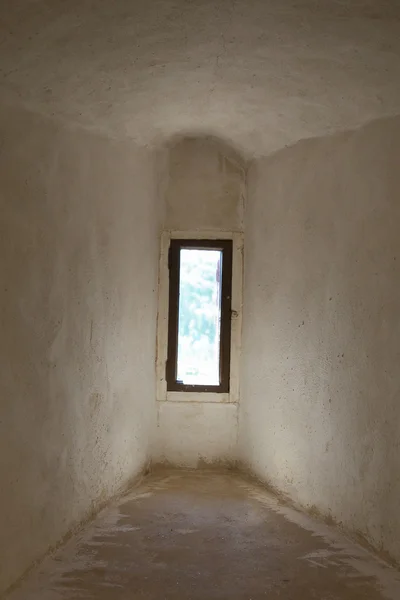 Narrow window in medieval corridor — Stock Photo, Image