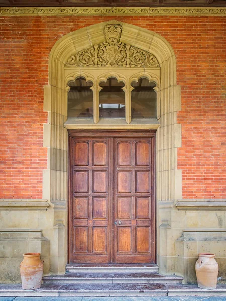 Victorian era doors in the brick antique castle wall