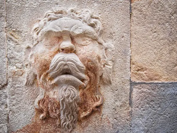 Bas-relief on ta wall of the face of an antique Greek god — Stock Image Bas Relief Wall Face Antique Greek God Royalty Free Stock Images