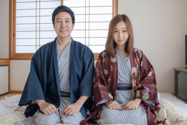 Couple in love wearing Tradditional Yakata cloth in Japanese tatami room style. Face look very happy and lovely feeling.