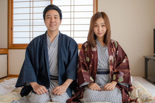 Couple in love wearing Tradditional Yakata cloth in Japanese tatami room style. Face look very happy and lovely feeling.