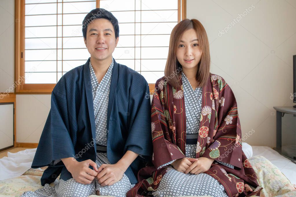 Couple in love wearing Tradditional Yakata cloth in Japanese tatami room style. Face look very happy and lovely feeling.