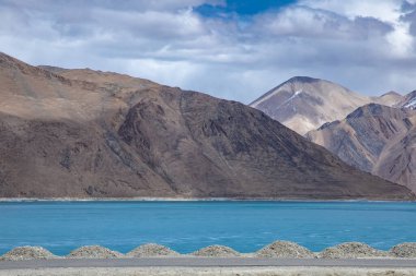 Hindistan 'ın Leh Ladakh kentini ziyaret eden Hintli ve Tibetli ve yabancı gezginler için kış mevsimi iken Himalayalar ve Donmuş Göl Pangong Tso yüksek çayırlık gölü manzarasını izleyin.