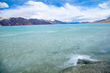Hindistan 'ın Leh Ladakh kentini ziyaret eden Hintli ve Tibetli ve yabancı gezginler için kış mevsimi iken Himalayalar ve Donmuş Göl Pangong Tso yüksek çayırlık gölü manzarasını izleyin.