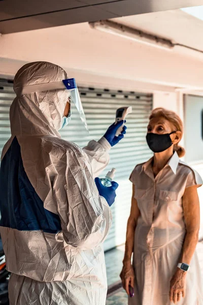 Officer Iført Respirator Maske Til Bruge Infrarød Pande Termometer Til - Stock-foto