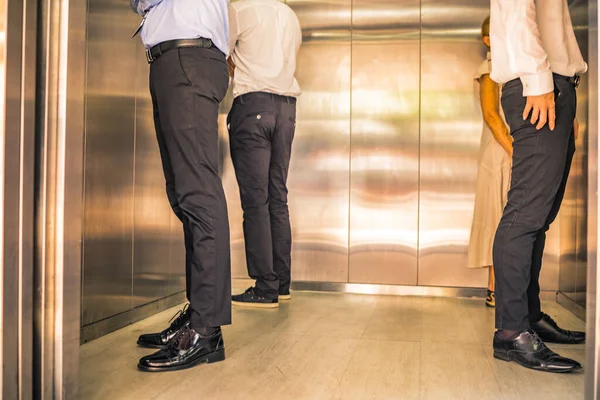 Social Distancing on Elevator with 4 passengers stand in the corner from outbreak of coronavirus covid19 situation. Concept of aware safe and low risk.