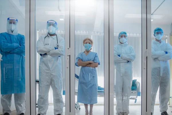 5 of Dortor, Nurse and patient looking out in the quarantine room from case of coronavirus covid 19. Virus infected patient with outbreak at hospital with coronavirus covid 19 disease treatment.