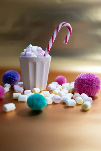 Tasse mit winzigen bunten Marshmallows und Weihnachtsdekoration — Stockfoto