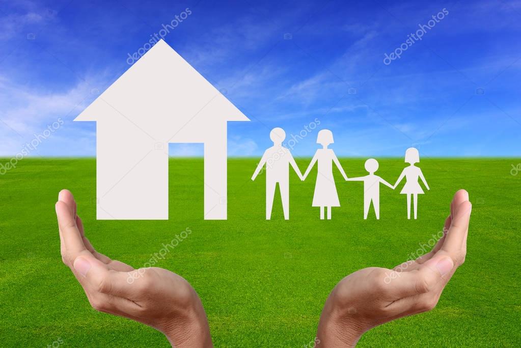 Hand holding house and family