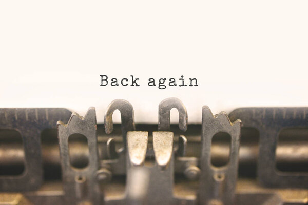 Typewriter with text Back Again
