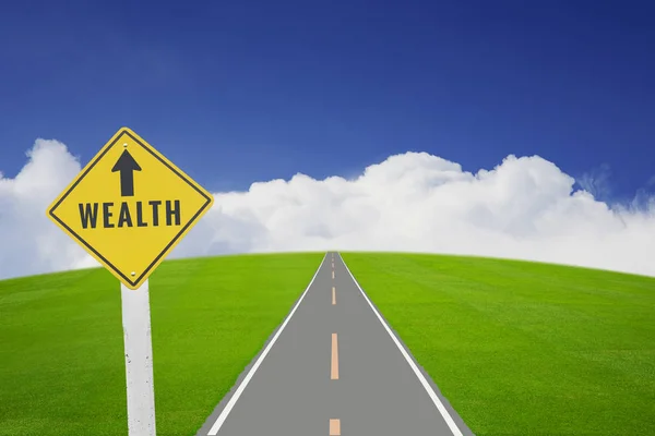 Wealth sign on long road — Stock Photo, Image