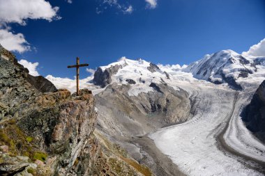The  wooden cross and glacier at Gornergrat station in summer, Z clipart
