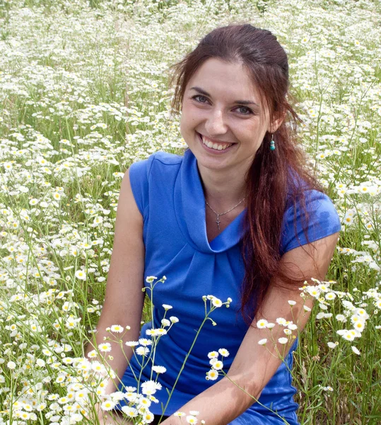 Beautiful woman  on a camomile field Royalty Free Stock Images