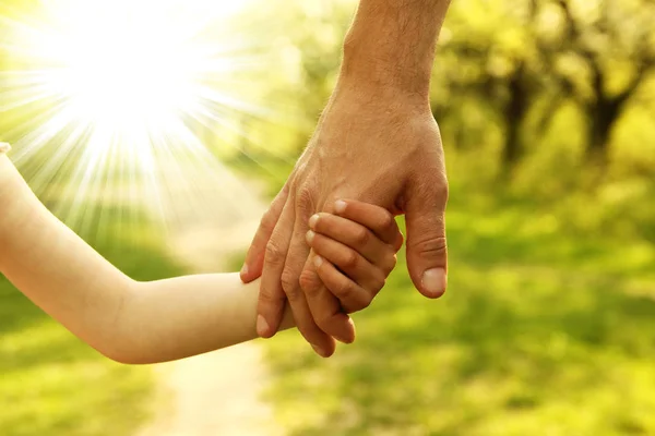 Parent carefully holds hand of child — Stock Photo, Image