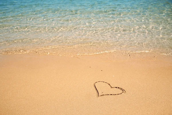 Beautiful drawing on the sand of the sea background — Stock Photo, Image