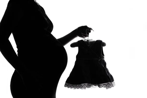 Silhouet van zwangere vrouw op een witte achtergrond — Stockfoto