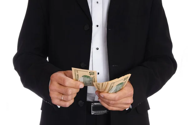 Homem de negócios segurando dinheiro em fundo branco — Fotografia de Stock