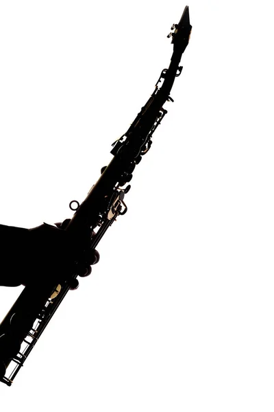 Saksofon na białym tle w rękach sylwetki muzyka — Zdjęcie stockowe
