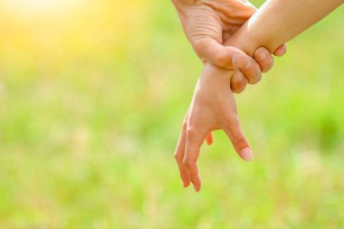 Yazlık parkta birbirine aşık mutlu bir çiftin elleri.