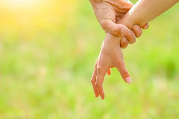 Händer av ett lyckligt par kär utomhus i sommarparken — Stockfoto