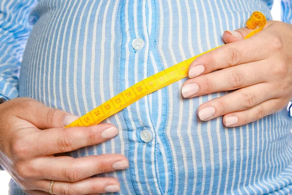 Happy pregnant girl lies on white background — Stock Photo, Image