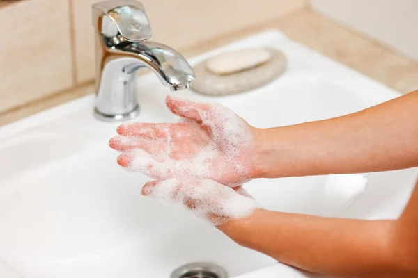 Hygiene concept. Washing hands with soap under the faucet with w — Stock Photo, Image