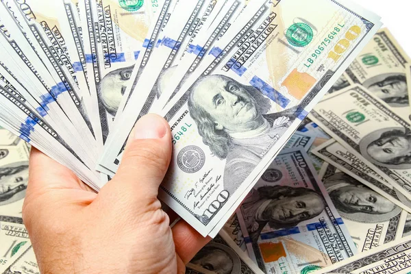 Dinheiro dólares nas mãos em um fundo branco — Fotografia de Stock