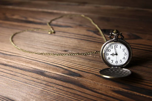 Pocket watch on a wooden background — Stock Photo, Image