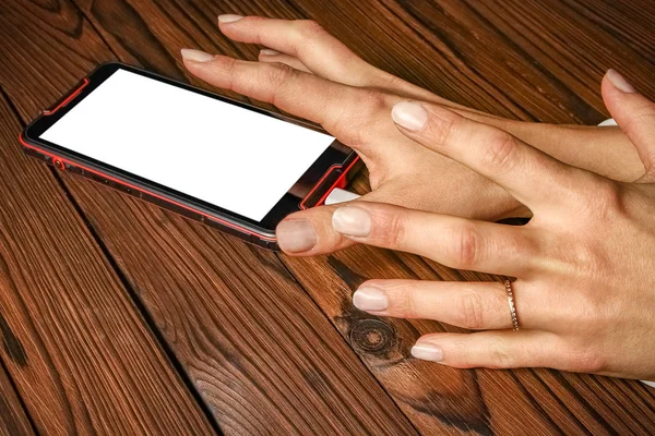 phone with hands addiction on a wooden background