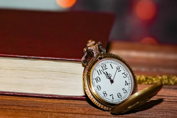 Pocket watch with book background — Stock Photo, Image