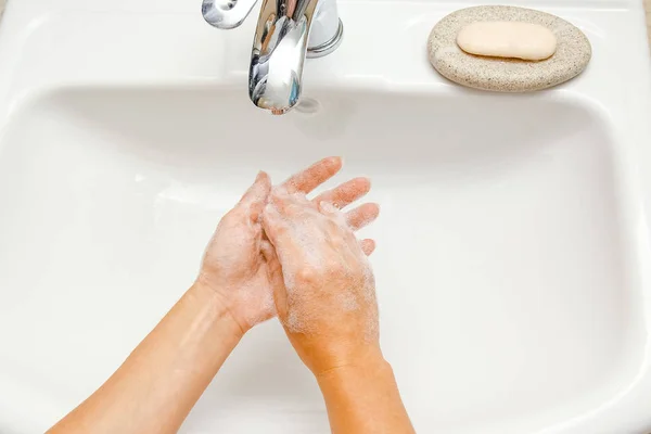 A Lavarse las manos con jabón debajo del grifo con agua —  Fotos de Stock