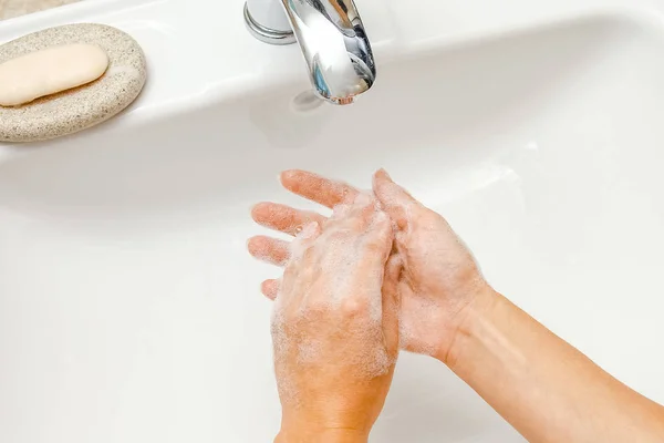 A Washing hands with soap under the faucet with water — Stock Photo, Image