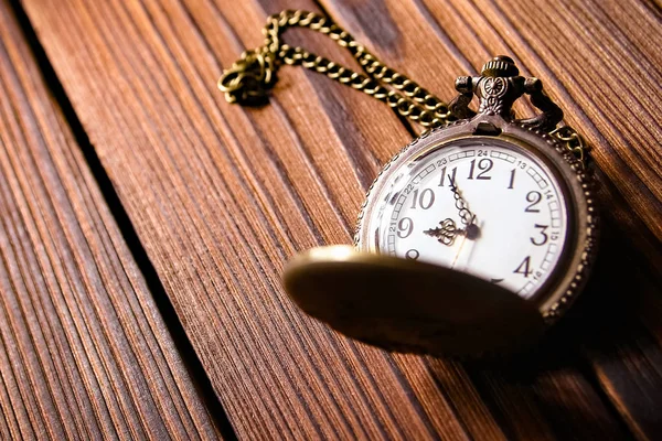 pocket watch on a wooden background