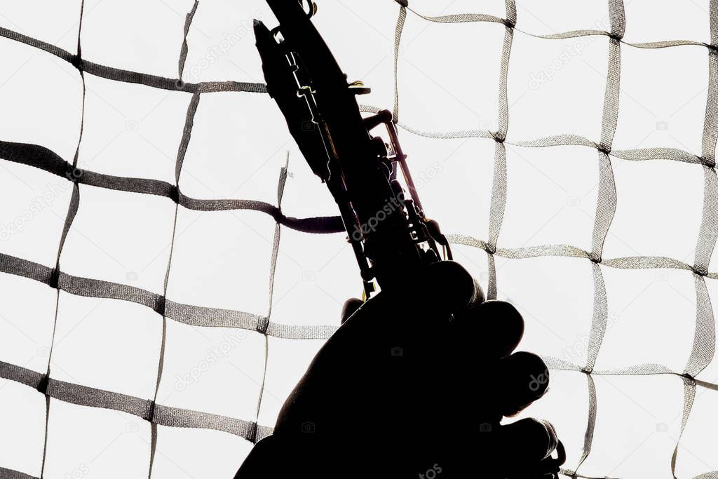 saxafon on a white background in the hands of a musician silhoue