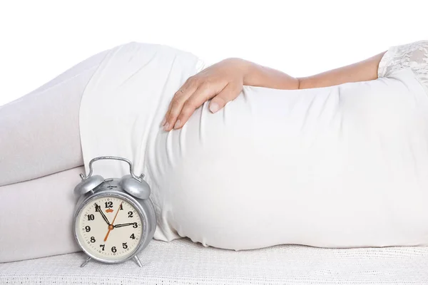 Happy pregnant girl lies on white background — Stock Photo, Image
