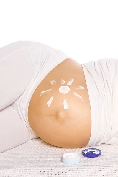 Happy pregnant girl lies on white background — Stock Photo, Image