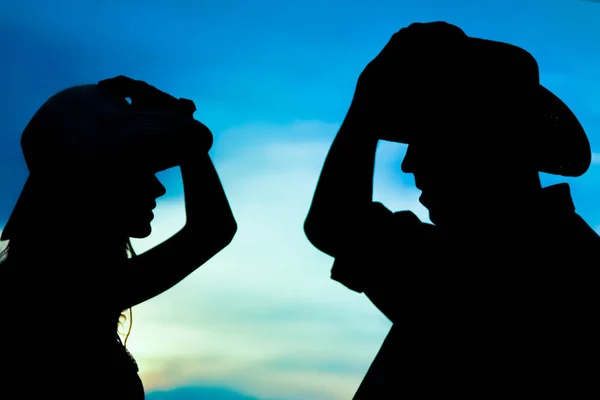 A happy cowboy couple silhouette background — Stock Photo, Image