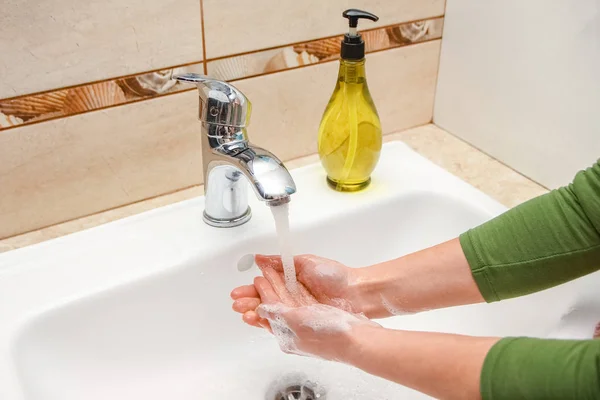 Ein Händewaschen mit Seife unter dem Wasserhahn mit Wasser — Stockfoto