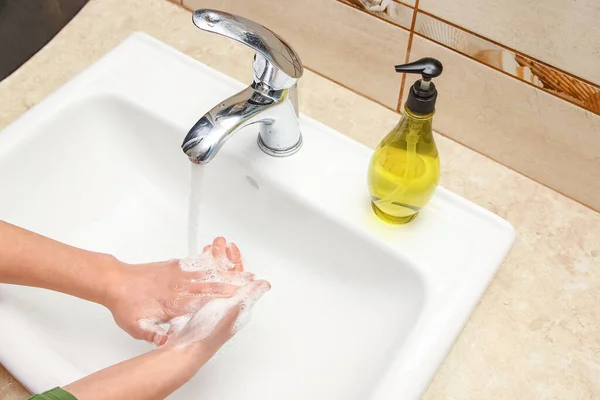 Ein Händewaschen mit Seife unter dem Wasserhahn mit Wasser — Stockfoto