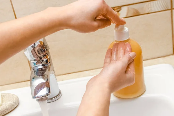 A Lavarse las manos con jabón debajo del grifo con agua — Foto de Stock